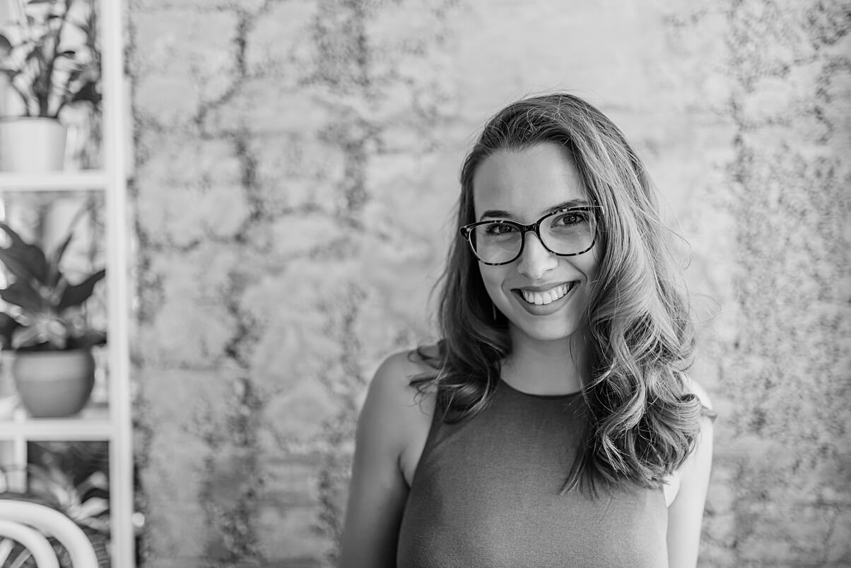 Headshot of gorgeous young woman with eyeglasses.